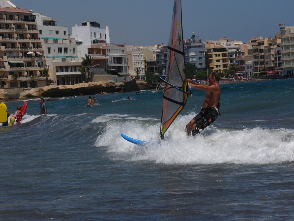 Windsurfing through swimmers
